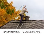 A Male Chimney Sweep Cleans The ...