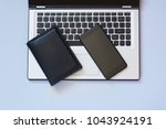 Open laptop, wallet and mobile on blue background. Business concept. Top view. Copy space.