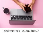 Typing text. Hand using gadgets, device on top view, blank screen with copyspace, minimalistic style. Technologies, modern, marketing. Negative space for ad. Coral color on background. Stylish, trendy
