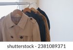 Small photo of Trench coat hanging on a hanger.