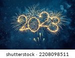 Happy New Year 2023. Beautiful creative holiday web banner or flyer with Golden firework and sparkling number 2023 on night blue sky background.