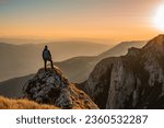 Small photo of A man who hikers enjoys a break look at the top of the mountain at sunset adventure travel.