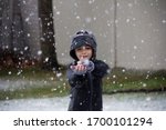 Little Boy Making A Snowball In ...