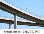 Elevated expressway during a sunny day .  highway overpass against blue sky .  Motorway viaduct interchange