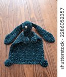 Small photo of Crochet, knitted, bunny rabbit mini blanket toy, homemade childrens toy for a baby, greeny blue velvet yarn