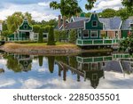 Merchant's house in Dutch Open Air Museum, Openluchtmuseum, Arnhem, Netherlands, July 29, 2022. Beautiful, old Dutch building with green authentic facade with reflection in the lake