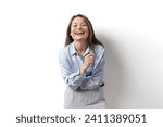 Small photo of An exuberant businesswoman laughing heartily, dressed in a blue shirt, embodying positivity and workplace joy