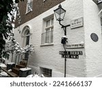 Small photo of London, UK - 12.12.2022. Holly Berry Lane street view, Hampstead. Old house facade. Winter in London, snow, snowing. London, England. Street view of Holly Berry Lane, Hampstead, London.