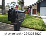 Black mailbox in front of a...