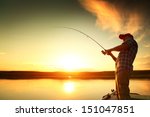 Young Man Fishing On A Lake...