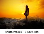 Young Woman Standing On Rock In ...