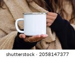 Small photo of Enamel White Mug with Gray Borderline Mock-up. Girl in camping clothes holding white old tin campfire cup. Camping mug mock up.