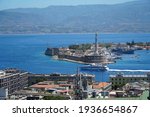 Small photo of MESSINA, ITALY - JUNE 9, 2020: Port of Messina, with its distinctive statue dedicated to the town's saint patron "Madonna of missive". A hydrofoil leaves from port to Reggio Calabria.
