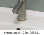 Faucet limescale. Dirty faucet with stain and limescale in bathroom. Selective focus, shallow depth of field.