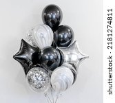 Small photo of A set of black and silver balloons with helium. Concept of holiday, happy birthday.