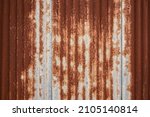 Full frame shot of a weathered and rusty corrugated iron roof, suitable as a industrial background texture