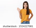Small photo of Friendly cheerful, happy smiling woman waving you with raised hand. Attractive girl greeting friend, say hello or hi, welcome guest, standing white background joyful, express positivity and joy
