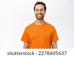Smiling happy man with closed eyes, dreaming of smth, thinking with pleased carefree face, standing over white background.