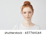 Portrait of beautiful redhead girl smiling looking at camera.