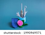Creative vase with tools: screwdriver, wrench. On a colored background, a pink rose, a blue tie and a vase with tools. Minimalism for Father's Day. Close-up, monochrome. Still life