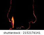 Small photo of burning paper, glowing edge of paper on a black background