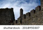 Small photo of Defensive walls and towers of the castle against the cloudy sky. High quality photo