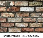 Old brick wall background, brick wall texture, structure. old broken brick, cement joints, close-up. crumbling from old age. construction, repair. concept of devastation, decline. High quality photo