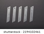 Cutter blades aligned on a black background