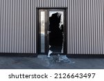 Broken glass door in shopping mall. Vandalism, burglary concept. Insurance concept. Cracked glass due to crime, robbery of shop concept.
