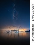 Small photo of Landscape image of milky way over traditional square fishnet equipment at Pakpra Canal, Phatthalung, Thailand