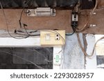 Small photo of Old Power socket with electric breaker attached to wood and concrete pillars of house structure. electrical panel board. Miniature circuit breaker and earth leakage circuit breaker Electricity.