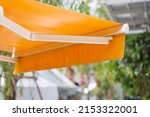 Small photo of yellow awning canvas of shop. yellow sun protection roof.