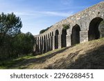 Small photo of Wonderful landscapes in Portugal. Beautiful scenery of Aqueduct of the Convent of Christ in Tomar. It is 6 kilometres long with a total of 180 arches. Sunny spring day. Selective focus