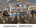 Small photo of Passengers at baggage carousel in baggage reclaim area in Salt Lake City International Airport, Salt Lake City, UT, USA, on May 11, 2023.