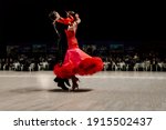 Small photo of dancers couple man in black tailcoat and woman in red ball gown