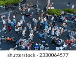 Small photo of Long Beach, CA - June 26, 2023: An aerial view of people dancing in Bixby Joe's Coffee parking lot while King Salmon and the Funk Yard Horns perform at the Concerts in the Park(ing lot) series.