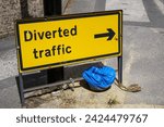 Small photo of Diverted traffic sign with directional arrow showing reroute. Inconvenience for motorists on road