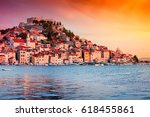Sunset in old town of Sibenik, Croatia. Waterfront view with reflection
