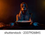 Small photo of Photo of savage valkyrie potion bowl pray oden before battle orange light mist isolated on black color background