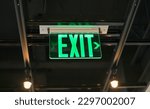 Small photo of exit sign in red and white color signifies a way out or emergency exit. It is an essential safety feature in public and commercial buildings, providing clear and visible guidance to people