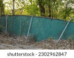 Small photo of Barbed wire fence symbolizes boundaries, security, and deterrence. It represents the division between spaces, protection, and acts as a visual deterrent to unauthorized entry