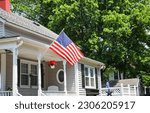 Small photo of US flag proudly displayed in front of an American house symbolizes patriotism, national identity, and love for one's country. It represents unity, freedom, and the values upon which the United States