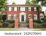 Small photo of suburban house stands empty, its foreclosure sign reflecting the financial recession and housing market crash, symbolizing the burden of mortgage rates
