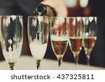 Man pours champagne in wineglasses