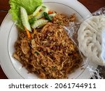 Small photo of Indonesian Javanese fried rice, usually seasoned with sambal ulek, onions, shrimp paste, and cooked with wood or a brazier. In addition, fried eggs, crackers, cabbage and cucumber are often added.