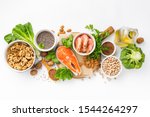 Food sources of omega 3 and omega 6 on white background top view. Foods high in fatty acids including vegetables, seafood, nut and seeds