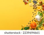 Set of various vegetables, fruits and berries for healthy and diet food on a yellow background with copy space top view