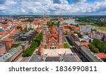 Szeged, Hungary - Aerial panoramic view of the Votive Church and Cathedral of Our Lady of Hungary (Szeged Dom) on a sunny summer day with Inner Town Bridge (Belvarosi hid) and blue sky and clouds