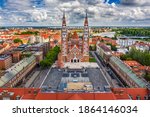 Szeged, Hungary - Aerial drone view of the Votive Church and Cathedral of Our Lady of Hungary (Szeged Dom) on a sunny summer day with Inner Town Bridge (Belvarosi hid) and blue sky and clouds