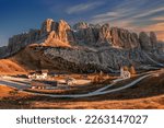 Gardena Pass, Italy - Panoramic view of the Brunecker Turm mountain (Mur del Pisciadu) belonging to the Sella group in the Italian Dolomites in South Tyrol, Italy with small chapel and a warm sunset